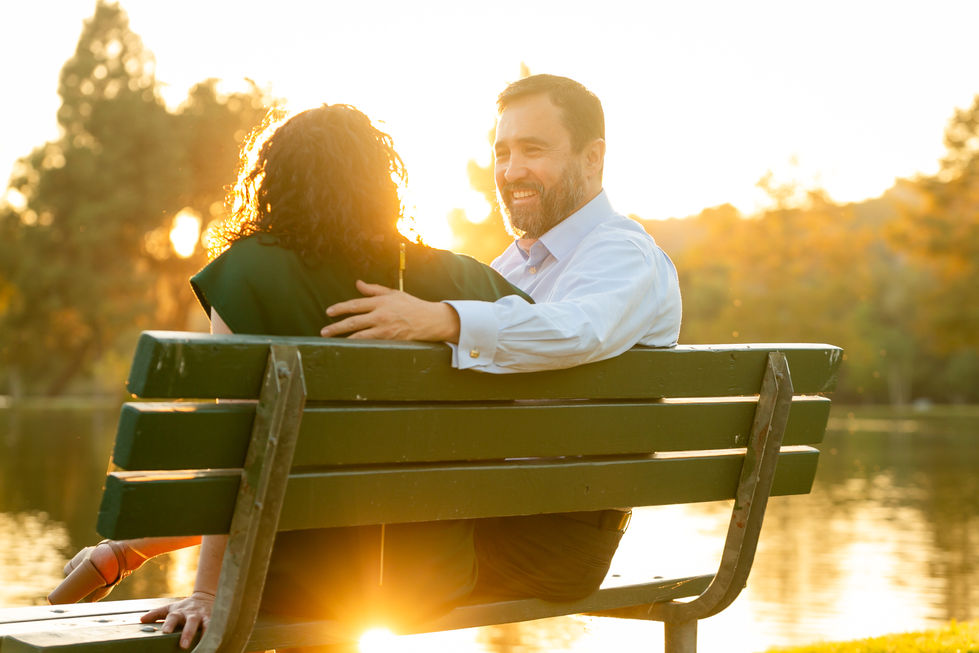 a man and a woman are sitting on a park bench