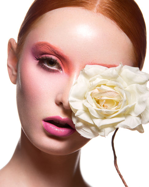 a woman covering her eye with a white rose