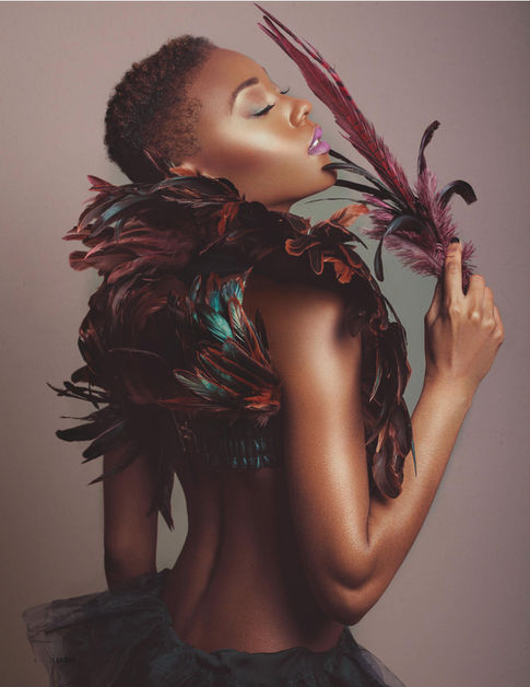 a woman with feathers around her neck and shoulder
