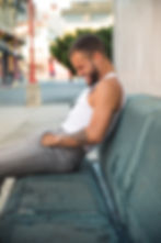 Man with tattoos laughing on bench by dating profile photographer