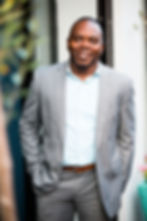 Smiling man in grey suit by a dating profile photographer