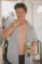 Man holding beer with open shirt, dating profile photographer