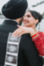 Couple holding sonogram photos by a couples photographer