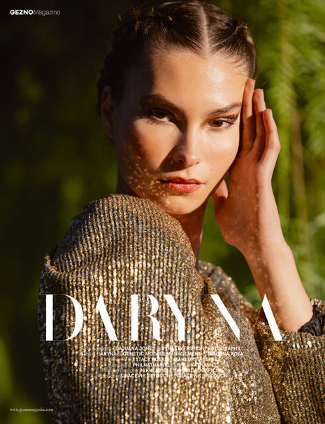 Woman in gold outfit with "DARYNA" text overlay.
