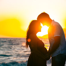 loving Couple on the beach taking a pic in the sunset