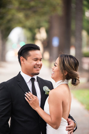 a bride and groom are looking at each other and smiling