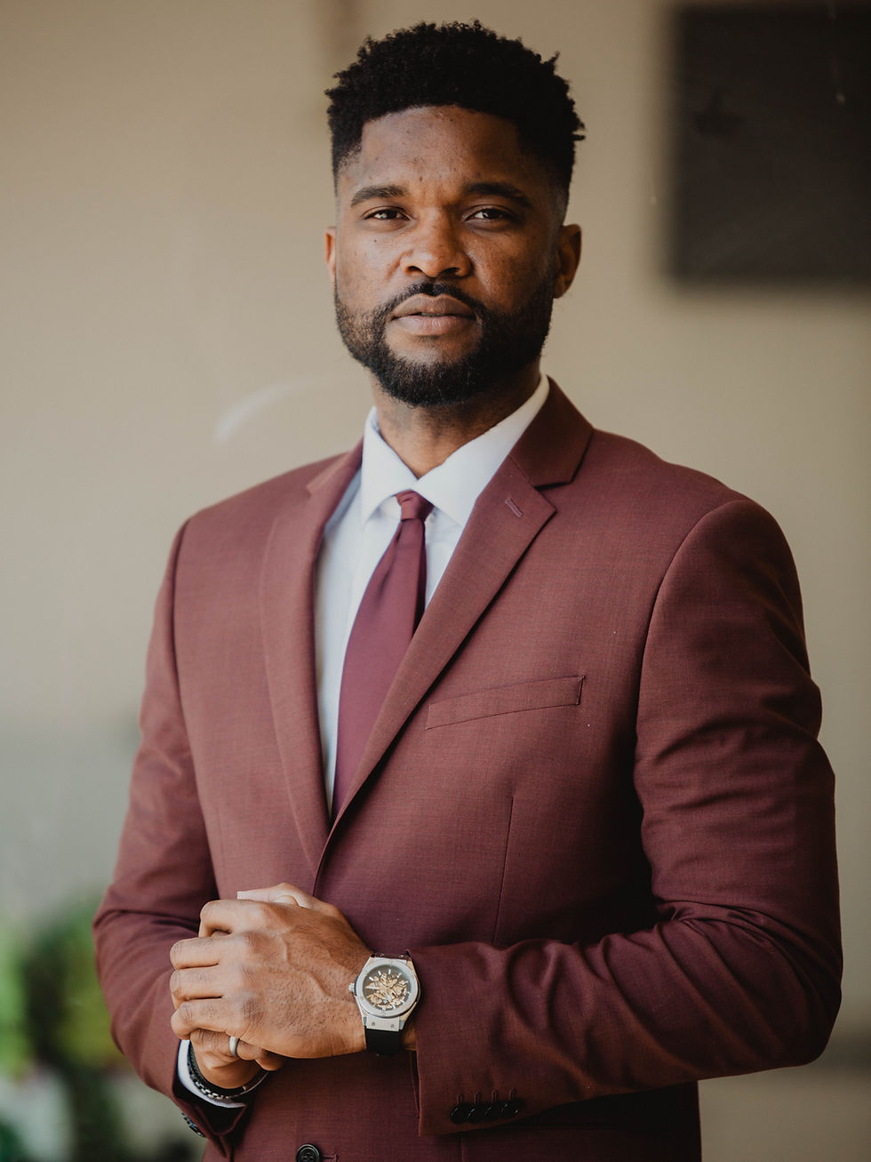 Professional realtor headshots orange county of a man in a maroon suit.