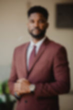 Man in a maroon suit for a photography portfolio