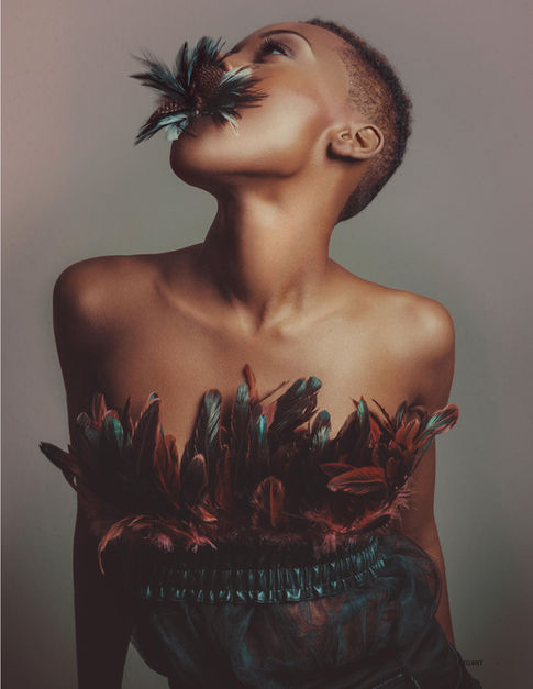 a woman with feathers on her chest is looking up