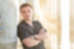 Man leaning against a pier post by a dating profile photographer