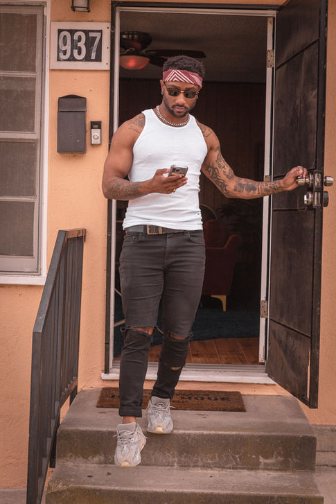 a man standing in front of a door looking at his phone