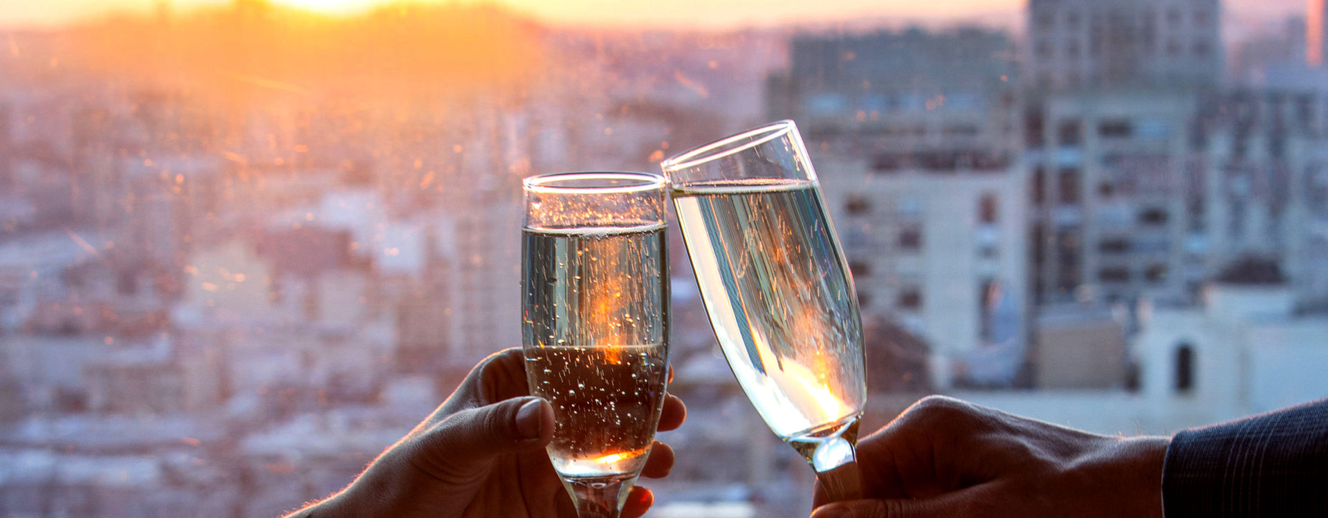 Photo of 2 people toasting with Champagne at the Top of the Mark.