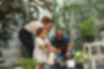 A photo of a family gardening