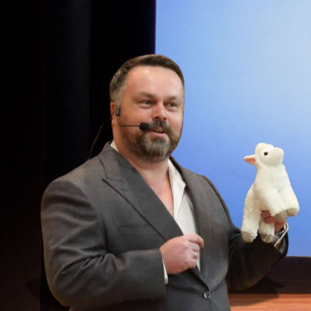 john presenting with toy lamb prop