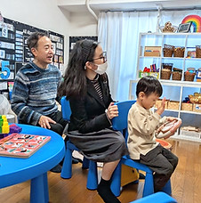 Forest Academy students and teachers playing on a pretend bus that they built