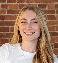 Sarah Ritchey headshot on brick.webp