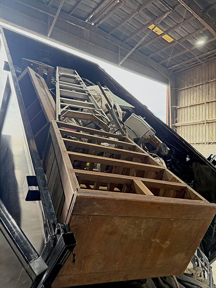 Dump trailer lifted all the way up and full of junk ready to be dumped at the landfill