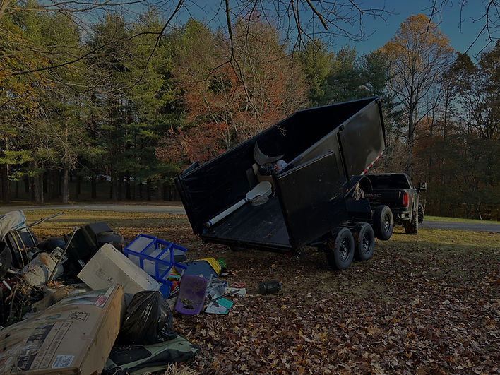 Dump body trailer lifted to dump trash onto the ground