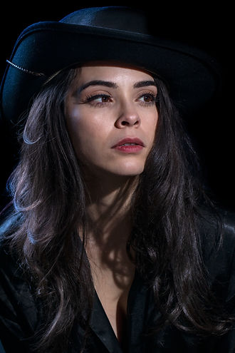 Portrait of Julia in a cowboy hat using mixed-color professional lighting.