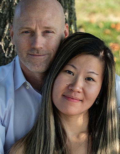 Engagement portrait of Juan and Robert beneath a tree in a local park.