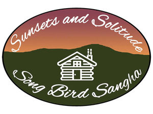 An oval logo with a mountain silhouette in green, sunset color sky above, and a white log cabin icon in the middle. The words "Sunsets and Solitude" are at the top and the words "Song Bird Sangha" are below.