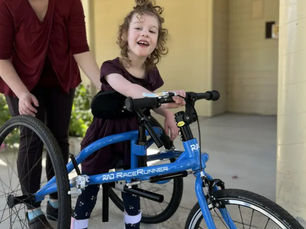 A girl on a blue running frame