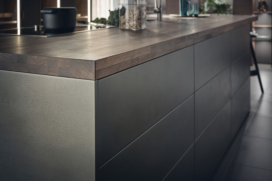 Sleek industrial kitchen cabinets complemented by exposed steel beams and pendant lighting