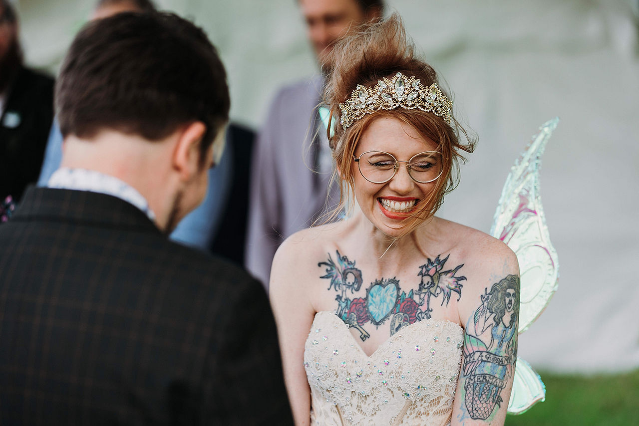 Bride beaming with emotion while exchanging vows during a personalised wedding ceremony
