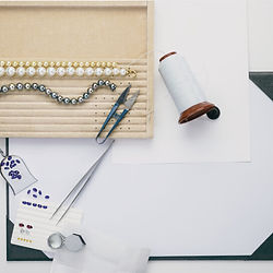 fine pearls being restrung with knots between pearls