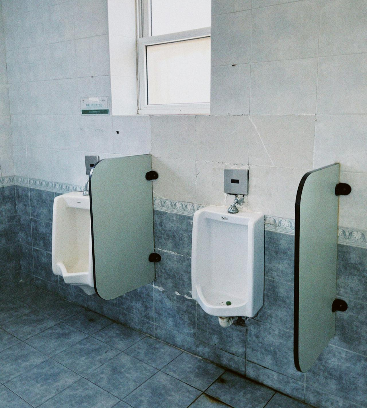 Two urinals in a commercial bathroom