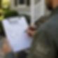 Closeup over-the-shoulder photo of a wildlife removal animal exclusion expert holding a cl