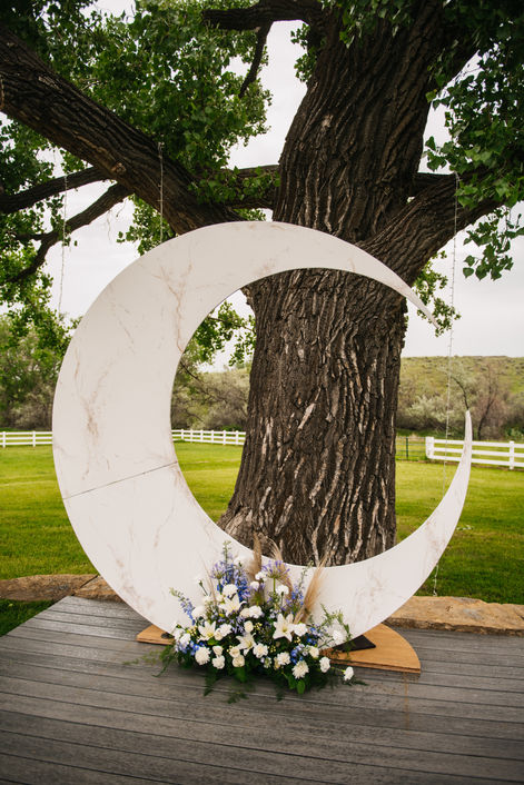 Custom crescent moon and fresh flower piece create wedding altar