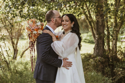 A groom kisses his bride on their wedding day in Montana