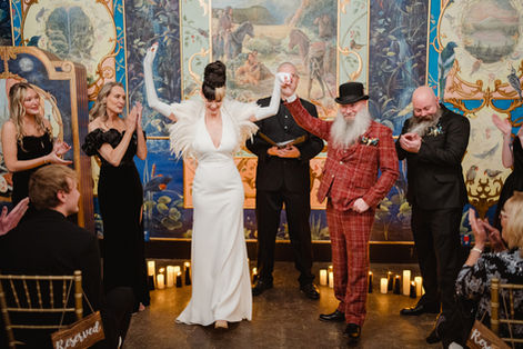 Bride and groom put their hands in their air to celebrate being married
