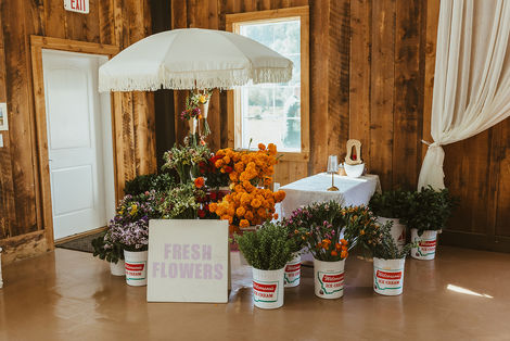 Bride and groom create a fresh bouquet station for their wedding guests