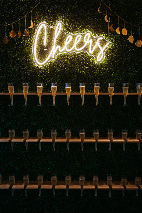 Champagne tower greets guests at wedding reception