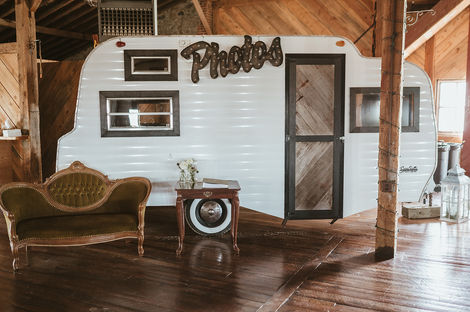 Small camper makes a photo booth at wedding reception