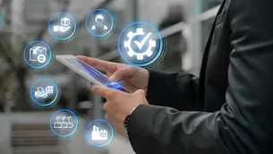 Hands holding a smartphone with digital logistics icons floating above. Background is blurred. Blue highlights create a techy mood.