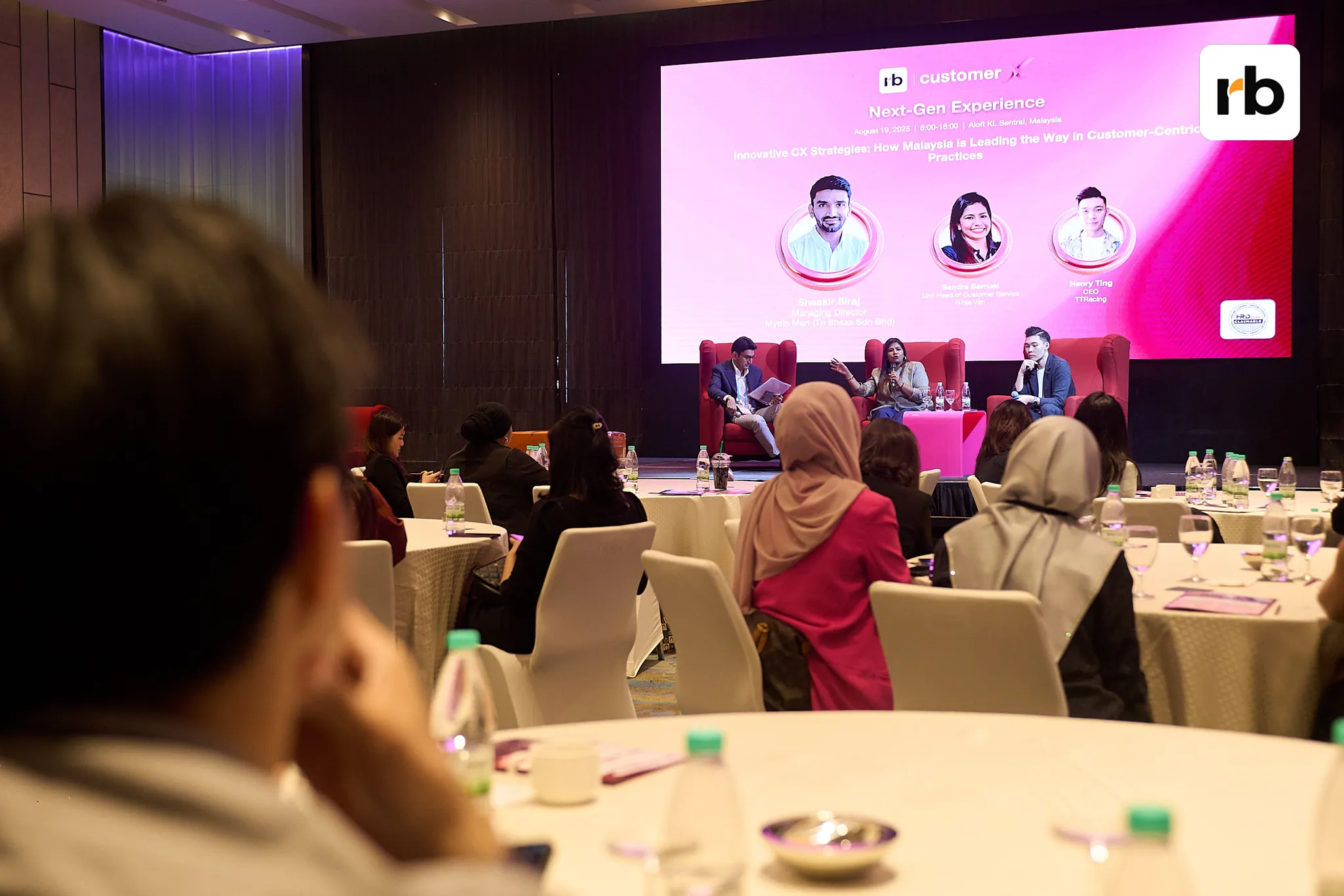 Networking in progress: Delegates connect and collaborate around round tables in a grand ballroom setting.