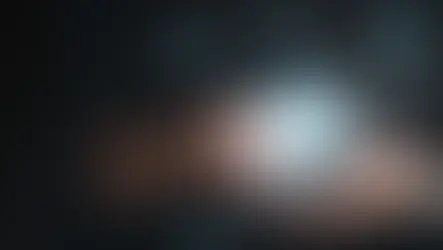 Hands hold a smartphone with a glowing cloud icon above it. Blue digital icons and binary code surround, suggesting technology and data.