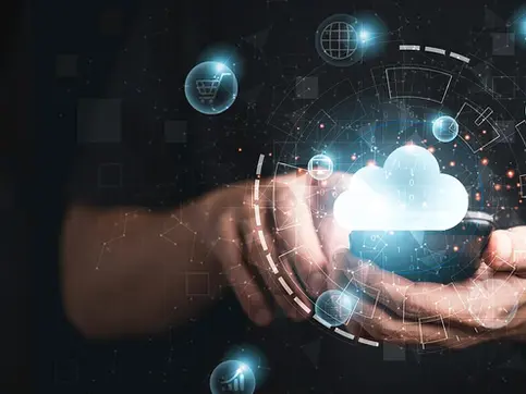 Hands hold a smartphone with a glowing cloud icon above it. Blue digital icons and binary code surround, suggesting technology and data.
