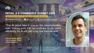 Retail conference banner in futuristic mall with robots. Text: "Retail & E-Commerce Summit Asia". Photo of a smiling man, Adrien Desbaillets.
