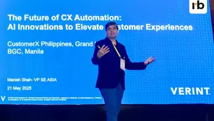 Verint’s Manish Shah speaking on stage, gesturing in front of a blue screen displaying "The Future of CX Automation" and event details in Manila, May 2025.
