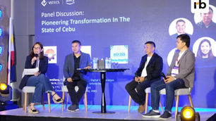 Panel of four people discussing at a Cebu innovation event, seated with microphones. Blue backdrop features the event title and logos.