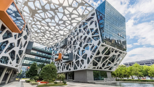Exterior view of Alibaba’s headquarters in Hangzhou featuring the modern geometric lattice architecture and glass buildings.