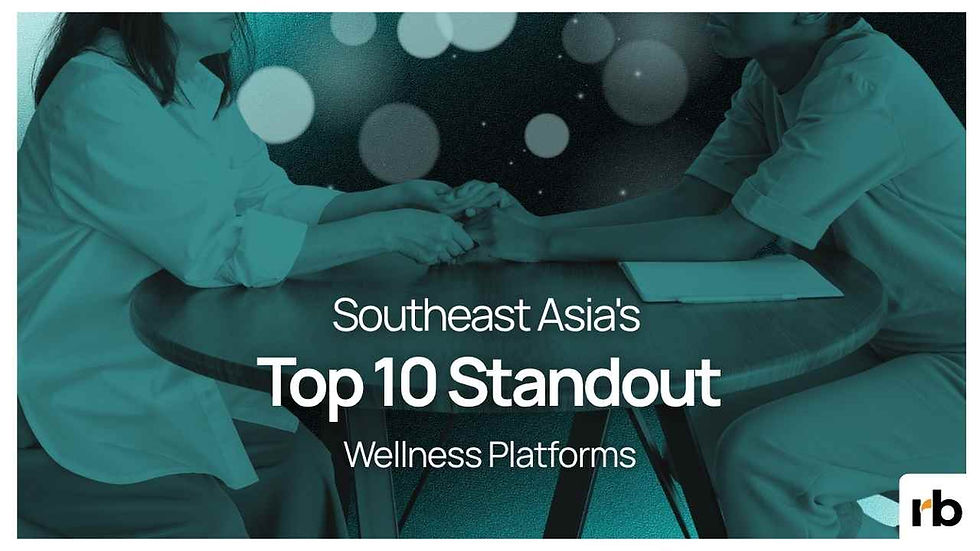 Two people in white sit at a table clasping hands over a teal graphic with text: Southeast Asia's Top 10 Standout Wellness Platforms.