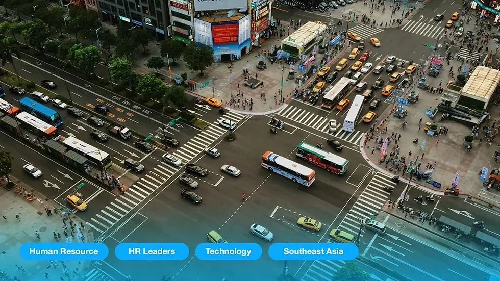 Busy city intersection from above with buses, cars, and pedestrians. Buildings surround the area. Text overlay: Human Resource, HR Leaders, Technology, Southeast Asia.
