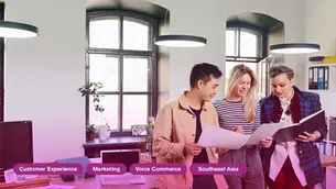 Three people reviewing documents in a bright office. Text: Customer Experience, Marketing, Voice Commerce, Southeast Asia.