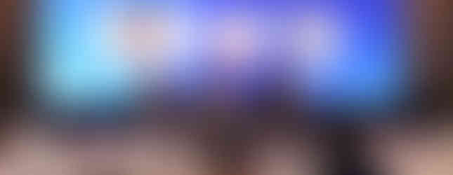 Insightful exchange underway as industry leaders deliberate on the future of talent development under the vibrant glow of the stage lighting.