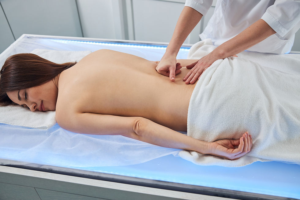 Woman receiving a deep tissue massage for sciatica. The setting is calm and relaxing.